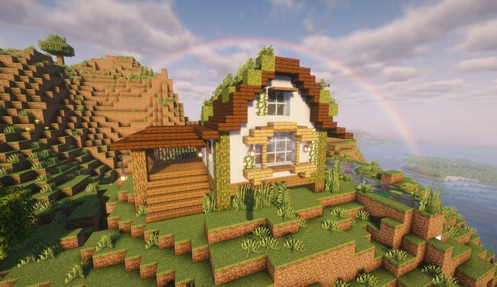 Rainbow Cottage: a white cottage on a terraced hill above the sea, with a rainbow behind it